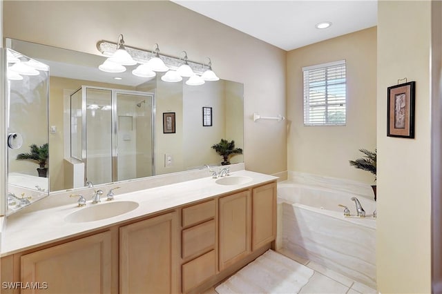 full bathroom with double vanity, a garden tub, a shower stall, and a sink