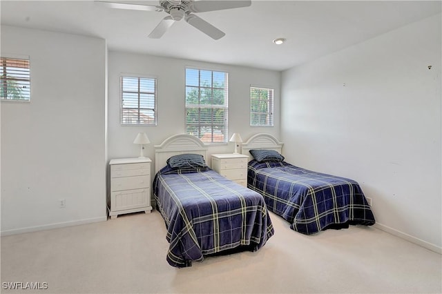 bedroom featuring baseboards, multiple windows, carpet flooring, and ceiling fan