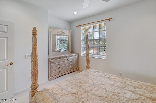 bedroom with light colored carpet, baseboards, and ceiling fan