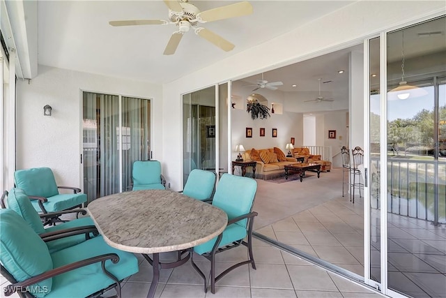 sunroom / solarium featuring a ceiling fan