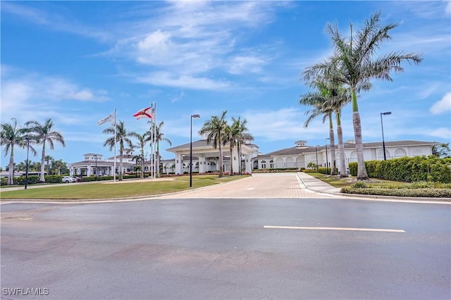 view of road with street lights and curbs