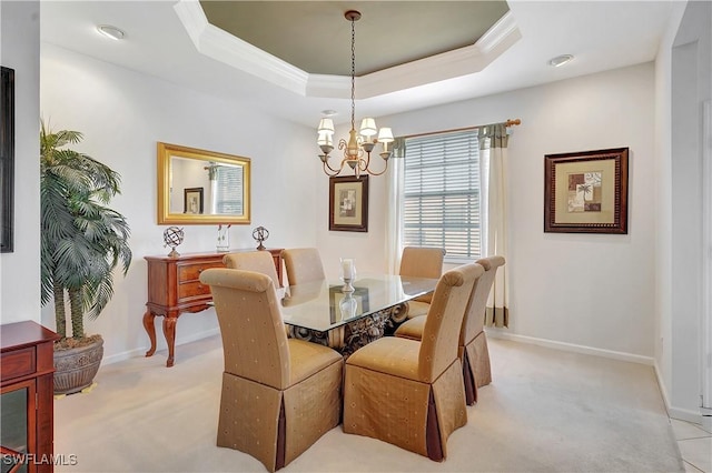 dining room featuring light colored carpet, ornamental molding, and a chandelier