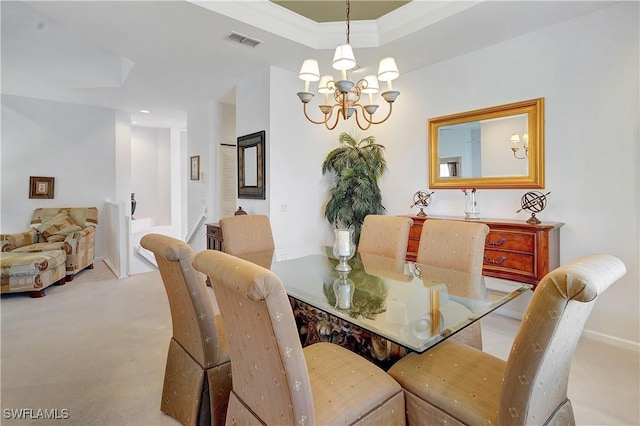 dining room with an inviting chandelier, visible vents, a raised ceiling, and carpet floors