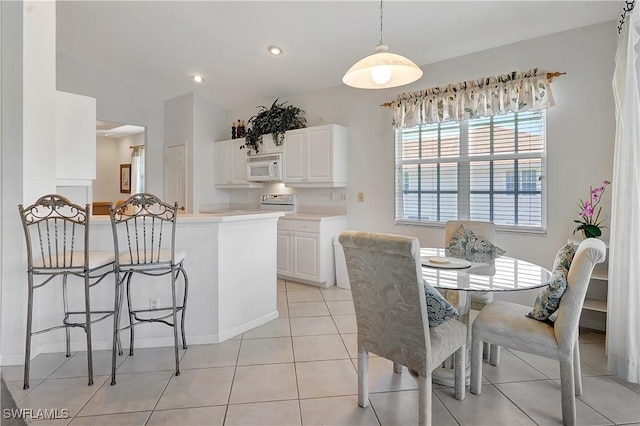 dining space with baseboards, recessed lighting, and light tile patterned flooring