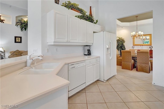 kitchen with light tile patterned floors, a sink, white cabinets, white appliances, and light countertops