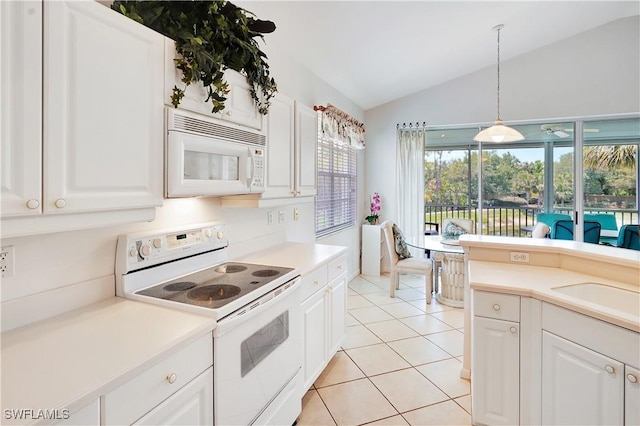 kitchen with lofted ceiling, white appliances, and white cabinets