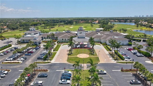 aerial view with a water view and view of golf course