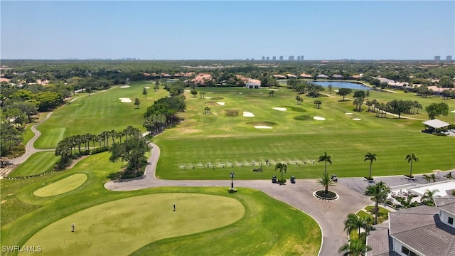 bird's eye view with a water view and golf course view