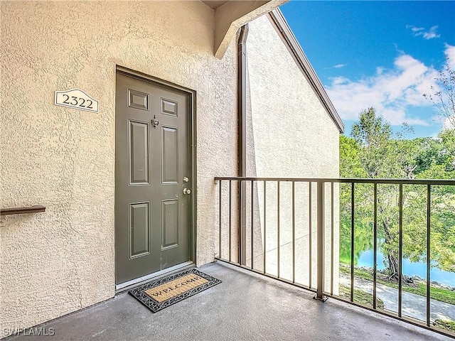 2178 Arbour Walk Cir Unit 2322, Naples, FL 34109 - view of exterior entry with stucco siding and a balcony