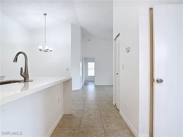 2178 Arbour Walk Cir Unit 2322, Naples, FL 34109 - hall featuring lofted ceiling, a sink, a chandelier, light tile patterned floors, and baseboards