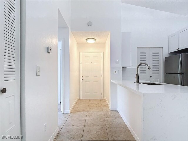 2178 Arbour Walk Cir Unit 2322, Naples, FL 34109 - hallway with a sink, baseboards, and light tile patterned floors