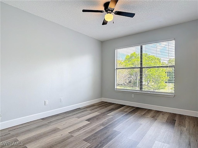 2178 Arbour Walk Cir Unit 2322, Naples, FL 34109 - unfurnished room featuring wood finished floors, baseboards, a textured ceiling, and ceiling fan