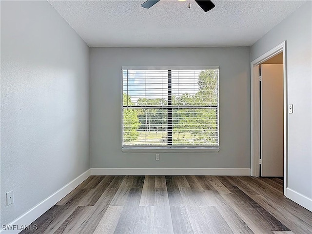 2178 Arbour Walk Cir Unit 2322, Naples, FL 34109 - empty room featuring wood finished floors, ceiling fan, a textured ceiling, and baseboards