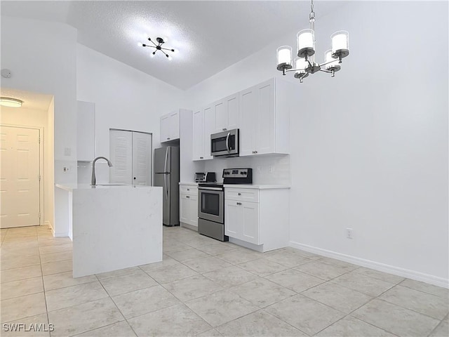 2178 Arbour Walk Cir Unit 2322, Naples, FL 34109 - kitchen with stainless steel appliances, light countertops, light tile patterned flooring, a chandelier, and high vaulted ceiling