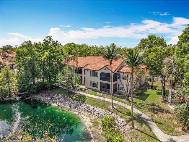 2178 Arbour Walk Cir Unit 2322, Naples, FL 34109 - back of house featuring a tile roof, stucco siding, and a yard