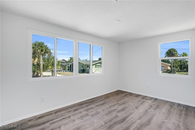 351 Jefferson Ct, Fort Myers Beach, FL 33931 - empty room featuring baseboards, a wealth of natural light, and wood finished floors