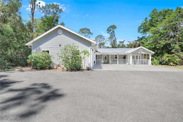 2855 66th St SW, Naples, FL 34105 - view of front of home featuring covered porch and driveway