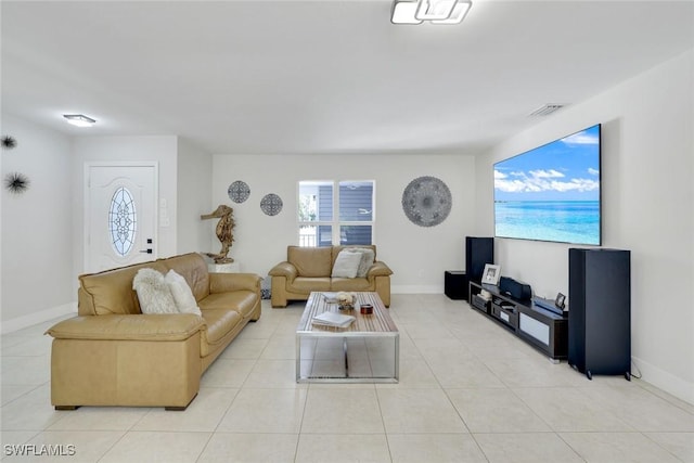 2855 66th St SW, Naples, FL 34105 - living room featuring light tile patterned floors and baseboards