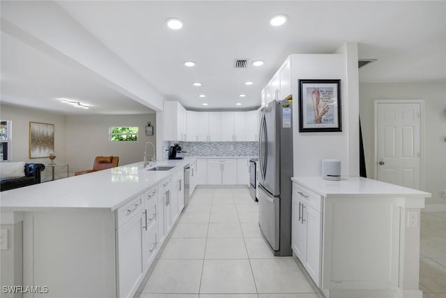 2855 66th St SW, Naples, FL 34105 - kitchen with a peninsula, stainless steel appliances, a sink, backsplash, and recessed lighting