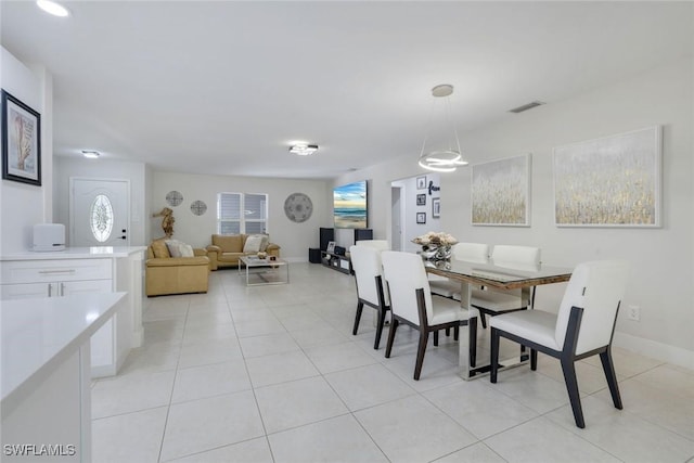 2855 66th St SW, Naples, FL 34105 - dining area with plenty of natural light, light tile patterned flooring, and baseboards
