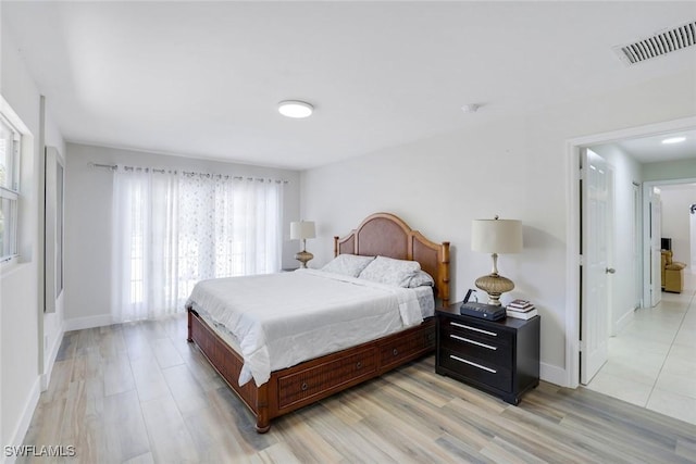 2855 66th St SW, Naples, FL 34105 - bedroom with light wood-type flooring and baseboards