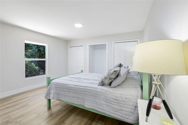 2855 66th St SW, Naples, FL 34105 - bedroom featuring two closets, baseboards, light wood-style floors, and recessed lighting