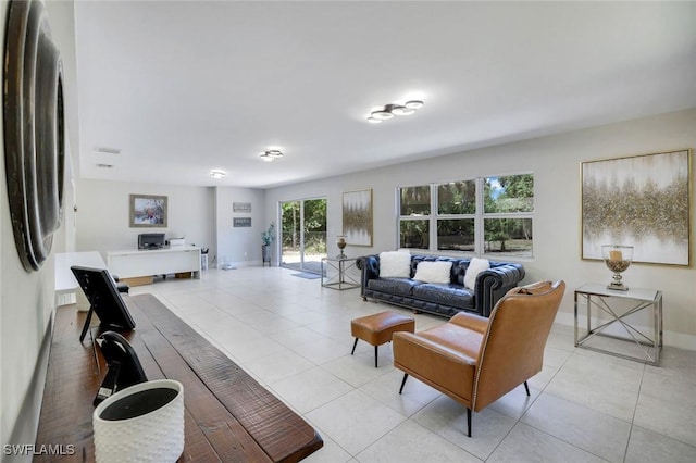 2855 66th St SW, Naples, FL 34105 - living area featuring light tile patterned floors, baseboards, and an office area