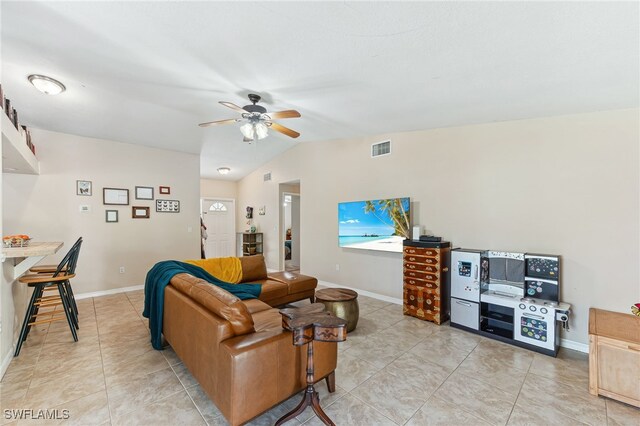 living area featuring visible vents, baseboards, ceiling fan, and light tile patterned floors