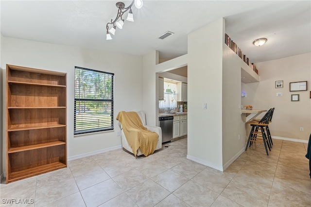 sitting room featuring baseboards, visible vents, and light tile patterned floors