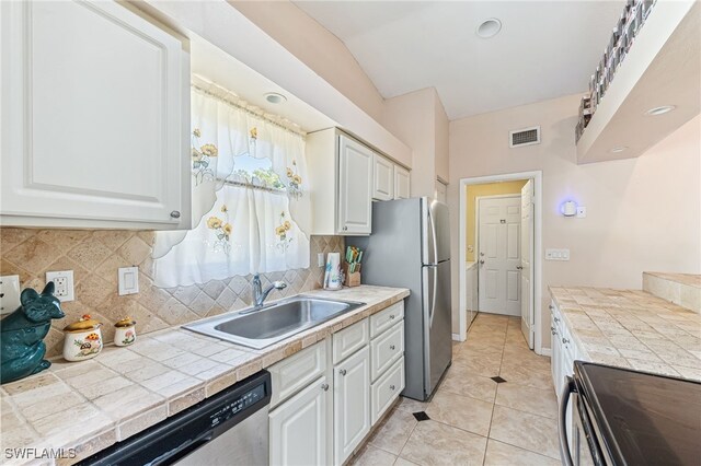kitchen featuring white cabinetry, appliances with stainless steel finishes, visible vents, and a sink