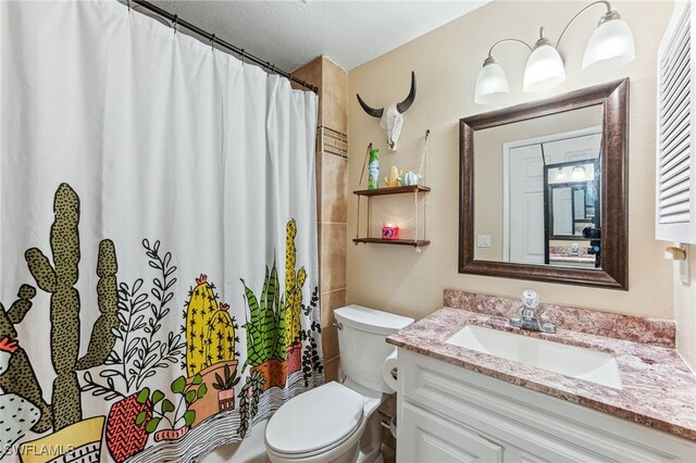 full bath featuring vanity, a textured ceiling, toilet, and a shower with curtain
