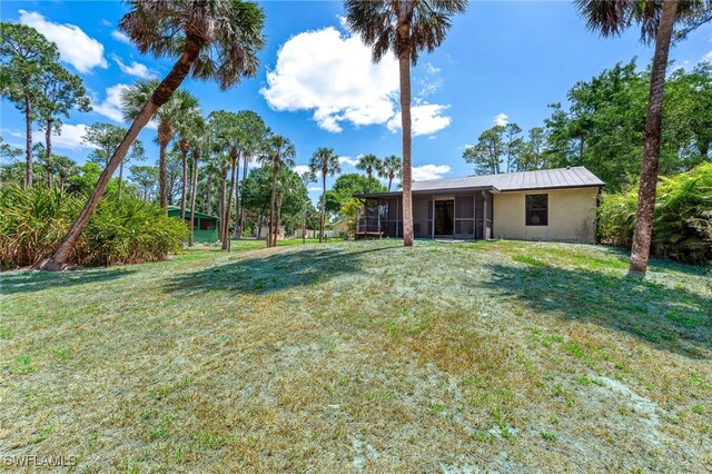 view of yard featuring a sunroom