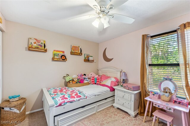 bedroom with baseboards, ceiling fan, and light colored carpet