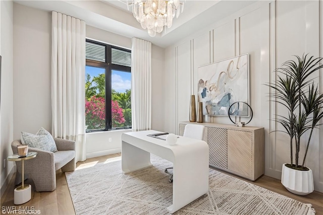 office space with an inviting chandelier and wood finished floors