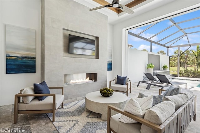 view of patio / terrace with a ceiling fan and an outdoor living space with a fireplace