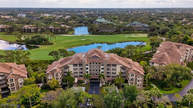 birds eye view of property with a water view and golf course view