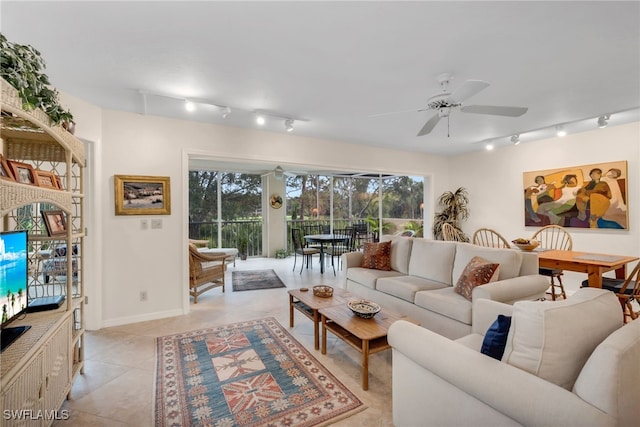 living room with baseboards, ceiling fan, track lighting, and light tile patterned floors