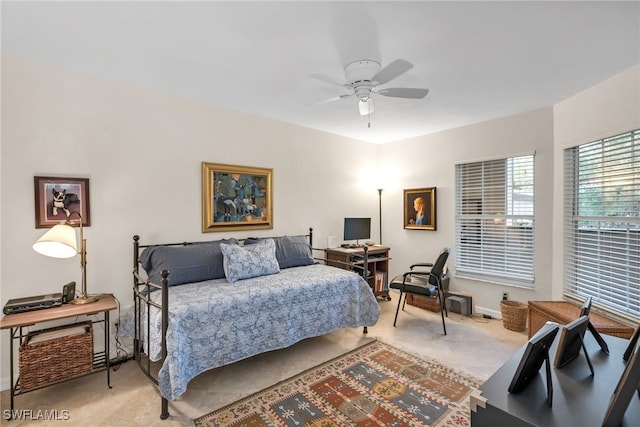 bedroom with baseboards, light colored carpet, and ceiling fan