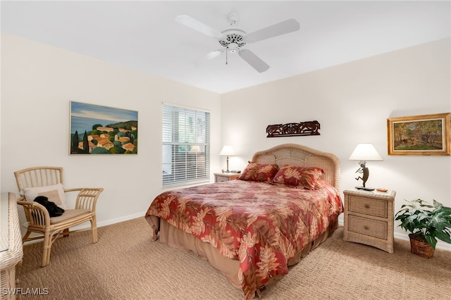 carpeted bedroom featuring baseboards and ceiling fan