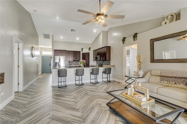 1045 SW Embers Ter, Cape Coral, FL 33991 - living area with ceiling fan, baseboards, and high vaulted ceiling