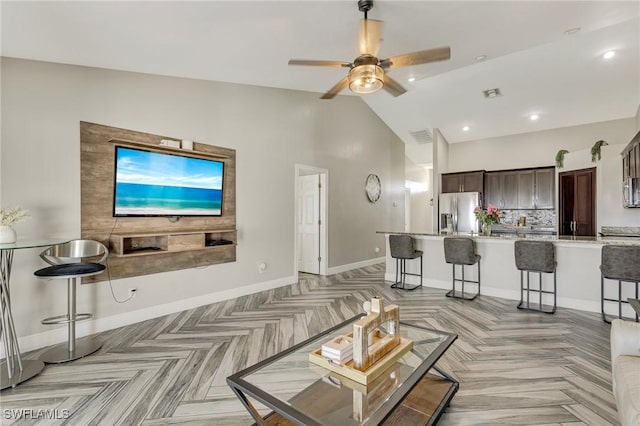 1045 SW Embers Ter, Cape Coral, FL 33991 - living room with a ceiling fan, baseboards, high vaulted ceiling, and recessed lighting