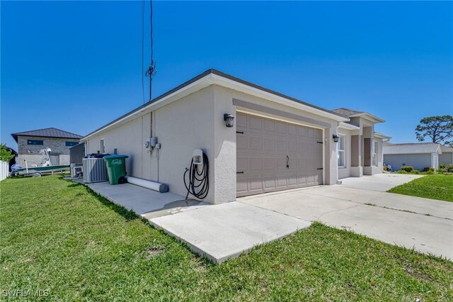 1045 SW Embers Ter, Cape Coral, FL 33991 - view of home's exterior featuring stucco siding, an attached garage, a yard, and concrete driveway