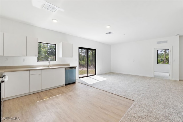 kitchen featuring white cabinets, dishwasher, visible vents, and a sink
