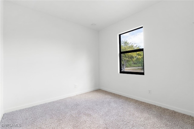 unfurnished room with baseboards and carpet floors