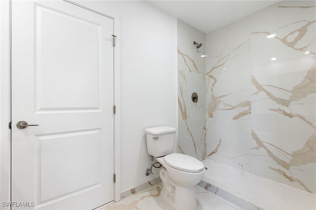 full bathroom featuring toilet and a marble finish shower