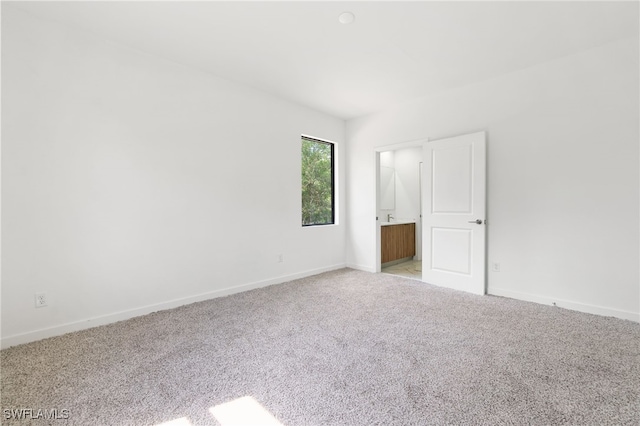 unfurnished bedroom featuring carpet flooring and baseboards