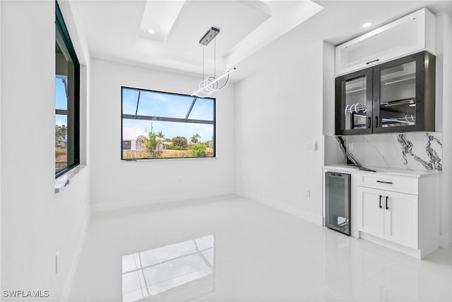 845 SW 15th Ter, Cape Coral, FL 33991 - interior space featuring a raised ceiling, recessed lighting, light tile patterned floors, wine cooler, and bar area