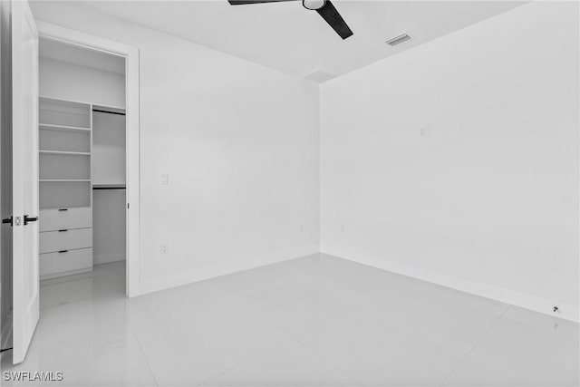845 SW 15th Ter, Cape Coral, FL 33991 - unfurnished bedroom with a walk in closet, ceiling fan, visible vents, light tile patterned floors, and a closet