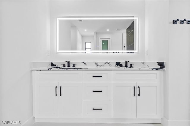 845 SW 15th Ter, Cape Coral, FL 33991 - bathroom featuring baseboards, a sink, and double vanity