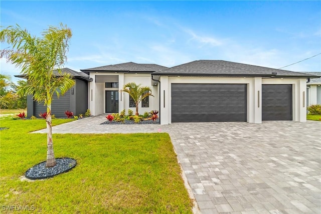 845 SW 15th Ter, Cape Coral, FL 33991 - view of front of house with stucco siding, decorative driveway, a front yard, and a garage